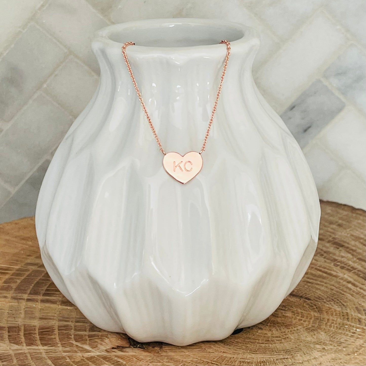 A little piece of Kansas City love. This KC necklace is the perfect way to show your love for your home town. With its simple and elegant design, the KC necklace is a must-have for any KC lover. The KC necklace makes the perfect gift for any occasion. Give the gift of love with the KC necklace. KC Heart Necklace Rose Gold 18K rose gold plated 18 inch necklace with 3 inch extender