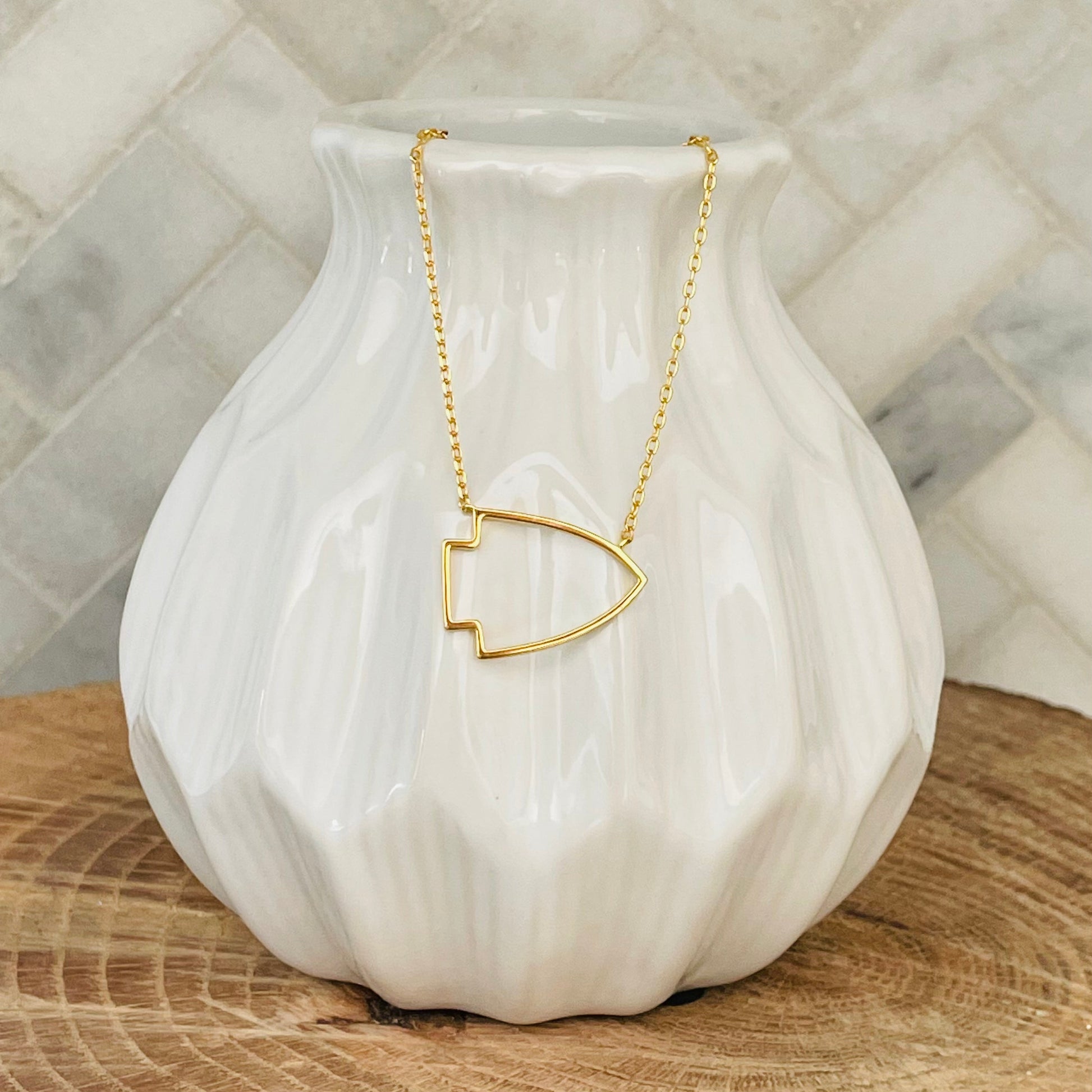 No matter where you go, you can show off your support for your favorite Kansas City team with this gold arrowhead necklace. Made of high-quality gold, this necklace is a must-have for any fan. Whether you're dressing up for a game or just accenting your everyday style, this necklace is a great way to show your KC love.  KC Arrowhead Necklace 18K gold plated 18 inch necklace with 3 inch extender